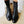 Zwarte leren veterlaarzen voor dames op houten vloer, modieuze enkellaarzen, stijlvolle schoenen, trendy herfst- en wintermode.