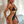 Vrouw in zwarte en gouden bandage badpak, sexy strandmode, trendy dames zwemkleding, zomer outfit, stijlvolle badmode, strandkleding.