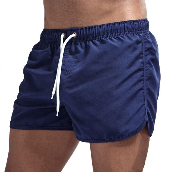 Donkerblauwe zwembroek voor heren met witte trekkoord, comfortabele pasvorm, ideaal voor strand en zwembad. Stijlvolle zwemkleding voor zomer.