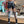Dames sportlegging met koeienprint en oranje strepen, fitnesskleding in moderne boetiek, trendy en comfortabel voor workouts.
