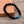 Zwarte lavasteen armband met blauwe pijlvormige kralen, stijlvol en modern, perfect voor herenaccessoires, op houten achtergrond.