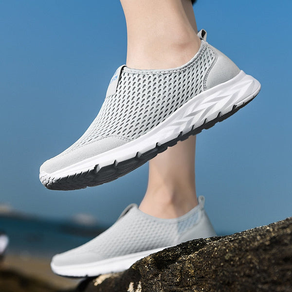 Grijze ademende sportschoenen voor dames, lichtgewicht en comfortabel, ideaal voor hardlopen en wandelen, met witte zool en mesh bovenwerk.