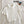 Witte geribbelde polo crop top op bed met bril en Matisse boek. Trendy dameskleding, casual stijl, zomeroutfit, modieuze top.