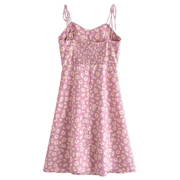 Roze zomerjurk met gele bloemenprint, spaghetti bandjes en gesmokte taille. Perfect voor casual en zomerse outfits. Vrouwelijke mode.
