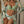 Lichtgroene bikini met bloemenprint, gedragen door model met bijpassende kimono. Zomerse strandkleding, trendy damesmode, tropische stijl.