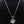 Zilveren ketting met ronde lotushanger, gedetailleerd ontwerp, op zwarte achtergrond. Perfect voor elegante sieradenstijl en spirituele symboliek.