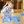 Jongen speelt met educatief puzzelspel op houten vloer, kleurrijke stukken met ruimtevaartthema, bevordert creativiteit en probleemoplossend vermogen.