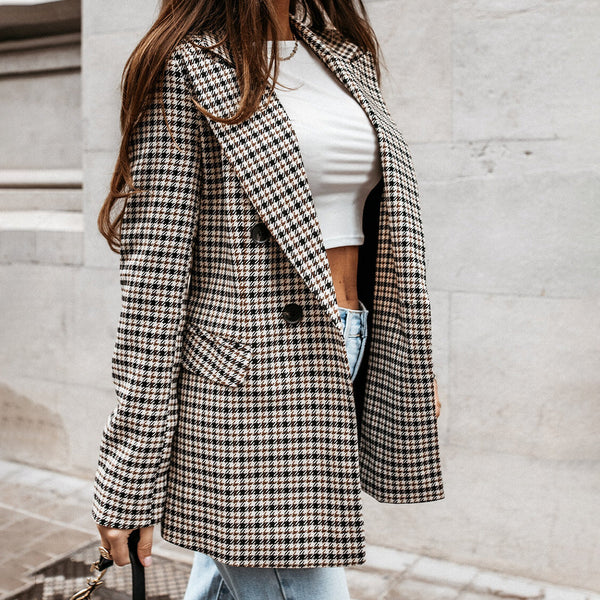 Vrouw in geruite blazer en witte crop top, casual mode, herfststijl, stedelijke achtergrond, trendy dameskleding, streetwear outfit.