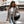 Vrouw in geruite blazer en spijkerbroek met zwarte schoudertas, loopt op straat. Mode, herfstkleding, stedelijke stijl, casual outfit.