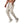 Man in beige joggers en sneakers met slangenprint, sportieve kleding, casual mode, comfortabele broek, trendy herenkleding, fitnessstijl.