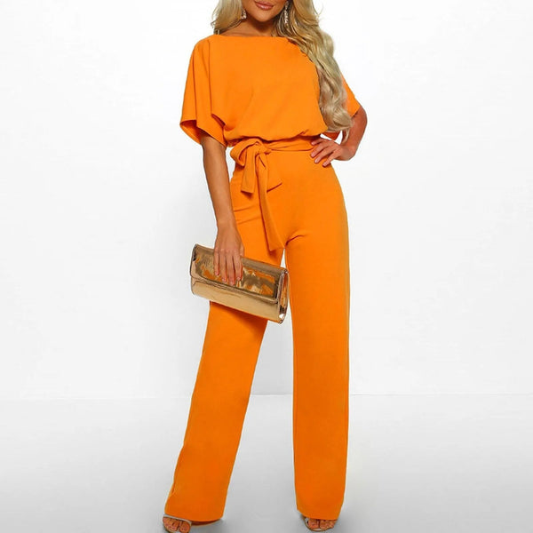 Oranje zomer jumpsuit voor dames met ronde hals en wijde pijpen. Inclusief ceintuur en clutch. Perfect voor feestelijke gelegenheden.
