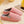 Roze pluchen pantoffels op beige tapijt, comfortabele winterse huisschoenen, warme voering, perfect voor binnengebruik, naast gele mok.