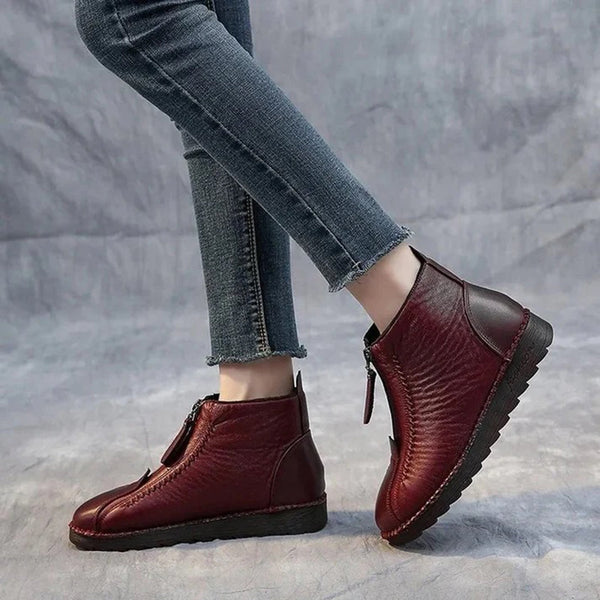 Rode leren enkellaarsjes met ritssluiting, gedragen met blauwe jeans. Comfortabele dameslaarzen, casual stijl, ideaal voor dagelijks gebruik.