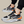 Moderne sportschoenen met zwart-wit design, oranje accenten en luchtkussenzool. Ideaal voor hardlopen en casual gebruik. Comfortabele sneakers.
