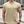 Man in beige T-shirt met ketting en horloge, buiten op stedelijke achtergrond. Casual herenkleding, mode, zomeroutfit.