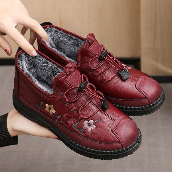Rode dames winterlaarzen met bloemenborduursel, warme voering en antislipzool. Perfect voor koude dagen. Comfortabele en stijlvolle schoenen.