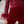 Rode jumpsuit met pailletten en veren, elegante avondkleding, fluwelen stof, lange mouwen, stijlvolle mode voor dames, feestelijke outfit.