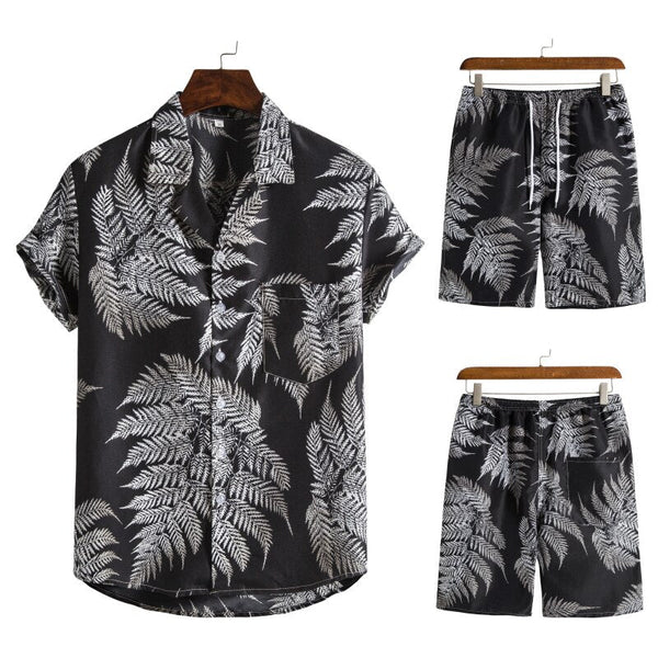 Zwart tropisch overhemd en korte broek set met witte varenprint, casual zomeroutfit voor heren, modieuze strandkleding.