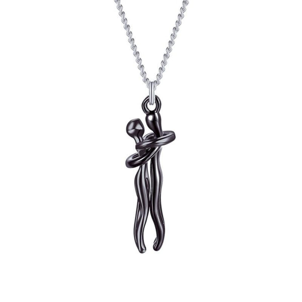 Zilveren ketting met zwart gepolijste hanger van omarmende figuren, modern design, minimalistische sieraden, unisex accessoire.