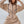 Vrouw in beige jumpsuit met capuchon en zwarte trekkoorden, modieuze streetwear, comfortabele pasvorm, trendy kledingstijl, casual outfit.