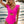 Vrouw in felroze badpak met ruches, strand op achtergrond, zomermode, strandkleding, trendy badmode, zeezicht, zonnige dag.