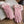 Roze suède handschoenen met bontvoering op een open boek, houten tafel. Wintermode, warme accessoires, stijlvolle dameshandschoenen.