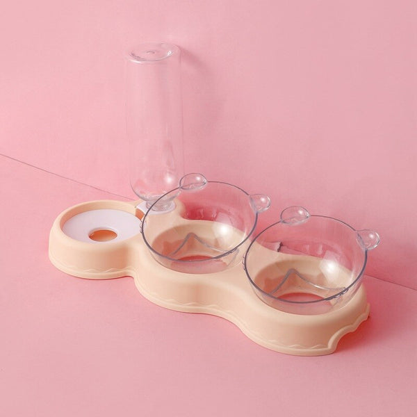 Transparante dubbele voerbak voor huisdieren met waterdispenser, roze achtergrond, kattenvoerbak, hondenvoerbak, huisdieraccessoires, modern design.
