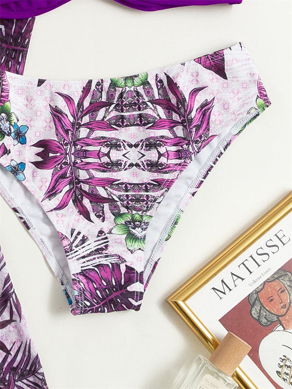 Dames bikini slip met kleurrijk tropisch bloemenpatroon, naast een Matisse kunstboek en parfumflesje. Perfect voor strandmode en zomerstijl.
