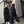 Vrouw in spiegelbeeld draagt zwarte wijde broek en wit crop top, met pet en sneakers. Trendy streetwear mode, casual outfit, urban stijl.
