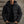 Man in zwarte gewatteerde winterjas met capuchon, casual stijl, buitenmuur achtergrond. Perfect voor koude weersomstandigheden en modieuze herenkleding.