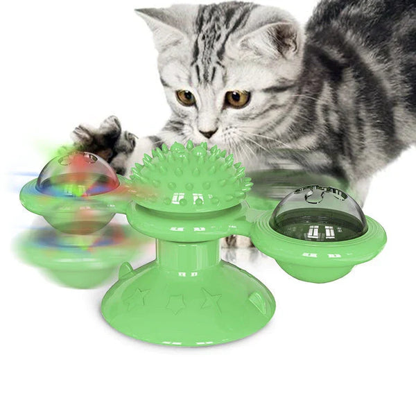 Grijze kat speelt met groene interactieve kattenspeelgoedspinner met LED-licht en zuignap, ideaal voor kattenvermaak en mentale stimulatie.