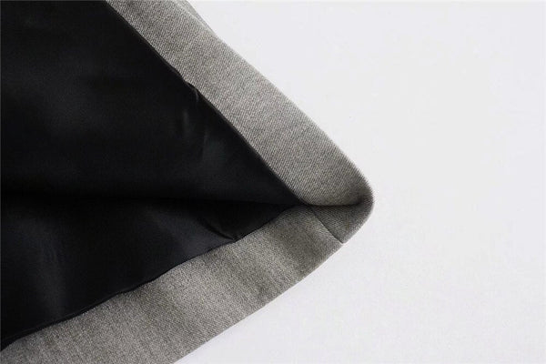 Grijze en zwarte stoffenrand, close-up van textielmateriaal, geschikt voor modeontwerp en kledingproductie.