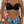 Vrouw in zwarte bikini top en blauw-zwart tropisch patroon bikinibroekje, zomermode, strandkleding, trendy badmode, stijlvolle dameskleding.
