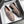Beige leren loafers met metalen kettingdetail in een open schoenendoos, stijlvolle damesschoenen, casual en elegant design.