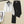 Witte hoodie met grijze capuchon en zwarte broek op hanger, stijlvolle casual outfit, moderne kleding, comfortabele mode voor dames.