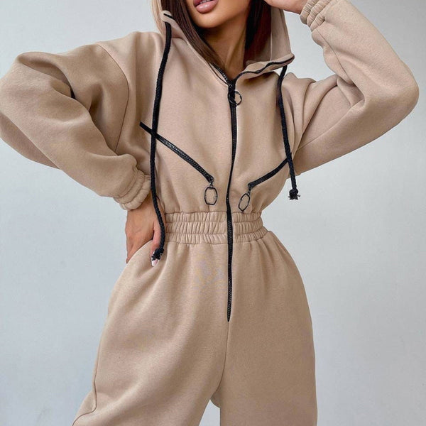 Vrouw in beige joggingpak met capuchon en zwarte ritsen, modieuze sportkleding, comfortabele loungewear, trendy damesmode.