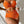 Oranje bikini met hoge taille en geribbelde textuur, vrouwelijk model, strandkleding, zomer, trendy badmode, flatterend ontwerp, zonvakantie.