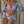 Vrouw in paarse bikini en bloemen kimono, draagt een zonnehoed. Zomerse strandmode, tropische print, stijlvolle badkleding.
