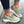 Mintgroene dames sneakers met witte zool en metallic details, gedragen op straat. Modieuze casual schoenen, perfect voor dagelijks gebruik.