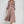 Elegante vrouw in zijden jurk met lange mouwen en knoopsluiting, modieuze avondkleding, beige tint, stijlvolle damesmode, glamour outfit.