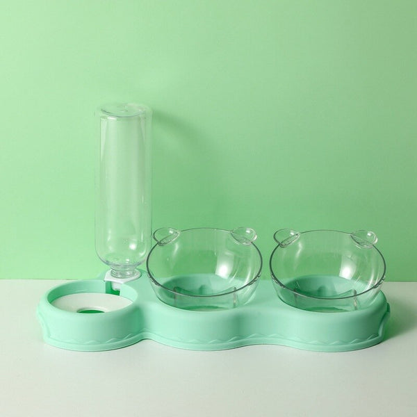 Dubbele kattenvoerbak met waterdispenser, transparante kommen en mintgroene basis. Ideaal voor huisdieren, stijlvol en functioneel ontwerp.