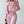 Vrouw in roze sportkleding, bestaande uit een tanktop, legging en hoodie, houdt een tas vast. Perfect voor fitness, yoga en casual mode.
