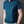 Man in blauwe polo met ritssluiting, korte mouwen, beige broek en horloge. Stijlvolle herenkleding, casual mode, moderne outfit.