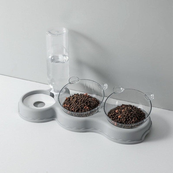 Grijze huisdier voerbak set met twee transparante kommen voor droogvoer en een waterdispenser. Ideaal voor katten en kleine honden.