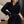 Vrouw in zwarte hoodie en rok, poseert voor spiegel. Modieuze dameskleding, casual stijl, comfortabele outfit, trendy herfstmode.