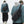Man in blauwe jas met zwarte crossbody tas, grijze hoodie en groene muts. Streetwear mode, casual outfit, stedelijke stijl, herenkleding.