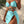 Vrouw in turquoise bikini met hartvormige details, omringd door tropische planten. Zomerse strandmode, trendy badkleding, stijlvolle strandoutfit.