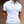 Witte polo met ritssluiting, korte mouwen, gedragen door een man. Stijlvolle herenkleding, casual en modern design, perfect voor zomermode.
