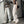 Vrouw in trendy streetwear met wijde beige broek en zwart crop top, reflecterend in spiegel. Mode, casual outfit, urban stijl.