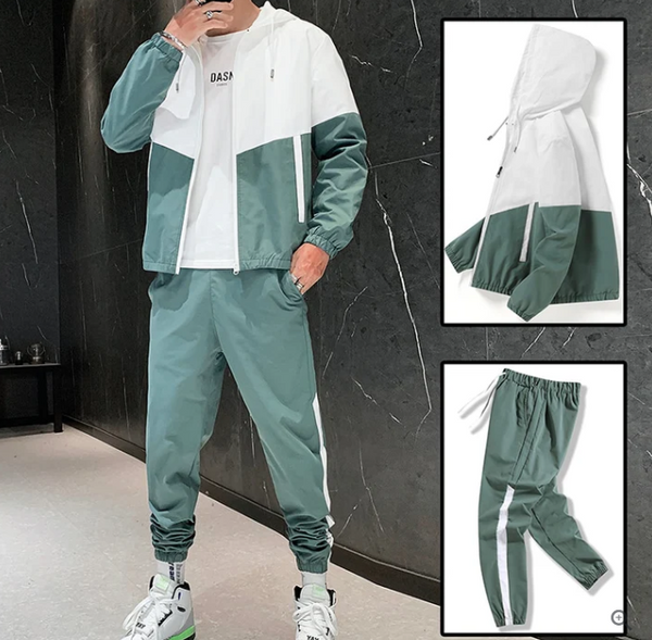 Groen-wit trainingspak voor heren, bestaande uit een jas met capuchon en joggingbroek. Sportieve outfit, ideaal voor casual en actieve gelegenheden.